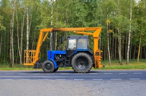 Specialized Cherry Picker Tractor in Motion on Country Road Stock-Fotos