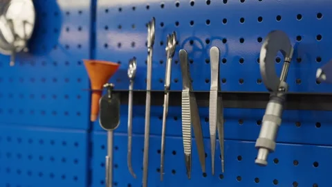 Specialized hand tools hanging on wall in automotive repair workshop Stock Footage 345173435