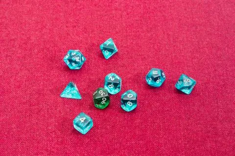 Specialized polyhedral dice for role-playing games on red cloth Stock Photos