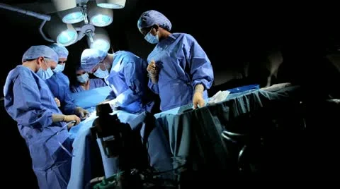 Specialized Team Performing Surgery in Operating Room Stock Footage 18744419