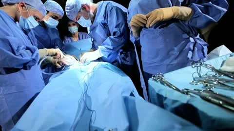 Specialized Team Performing Surgery in Operating Room Stock Footage