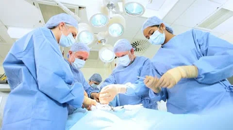 Specialized Team Performing Surgery in Operating Room Stock Footage 18753770