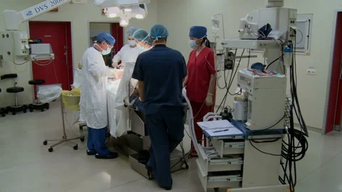 Specialized Team Performing Surgery In Operating Room Stockbeeldmateriaal 86330499