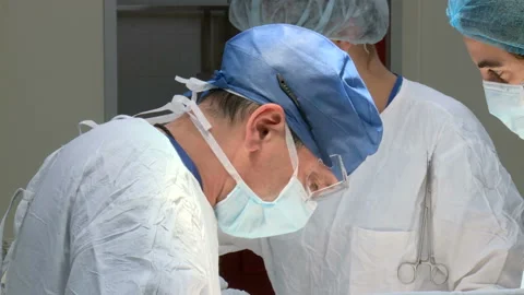 Specialized Team Performing Surgery In Operating Room Stock Footage