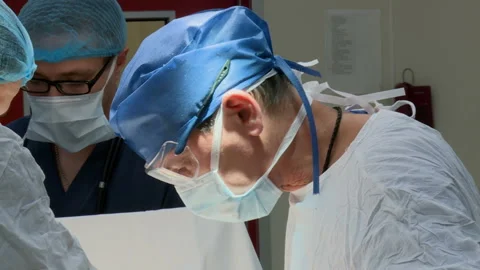 Specialized Team Performing Surgery In Operating Room Stockbeeldmateriaal 86330605