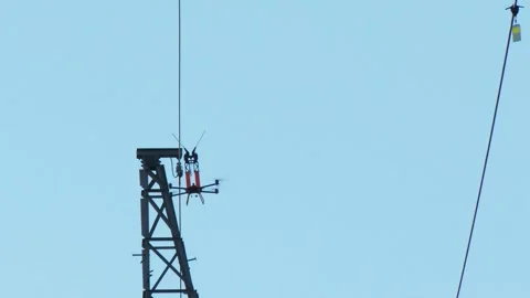 Specialized Utility Drone Working Between Transmission Towers Vídeo Stock 346307577