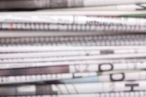 Specially defocused stack of newspapers blurred background Stock Photos