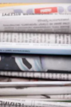 Specially defocused stack of newspapers blurred background Stock Photos