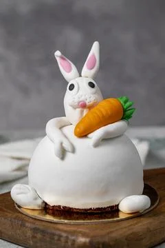 Specially designed bunny shaped cake. Cake on gray wooden table and Easter Bu Foto stock