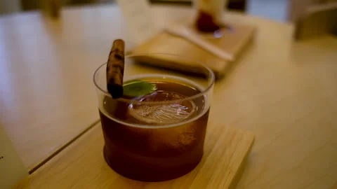 Specialty iced coffee served in a cozy café close-up 스톡 동영상 341687401