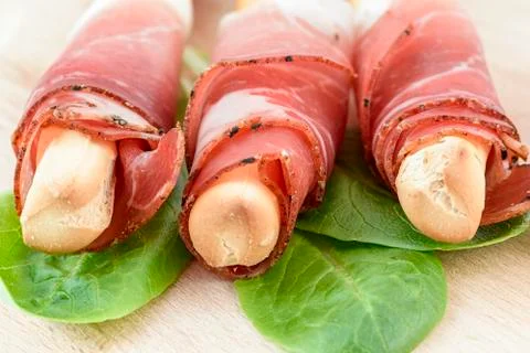 Speck breadstick on salad leaf Stock Photos