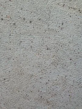 Speckled concrete wall surface texture close-up Stock Photos