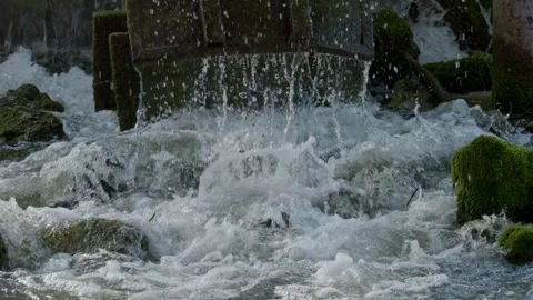 The spectacle of water cascading over rocks and moss evokes tranquility and Stock Footage 307960491