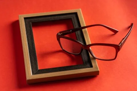 Spectacles and empty photo frame Stock Photos
