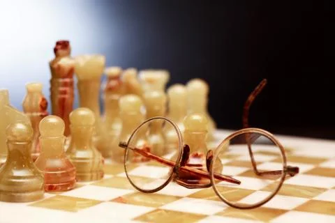 Spectacles On Chessboard Stock Photos