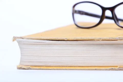 Spectacles lying on old book Stock Photos