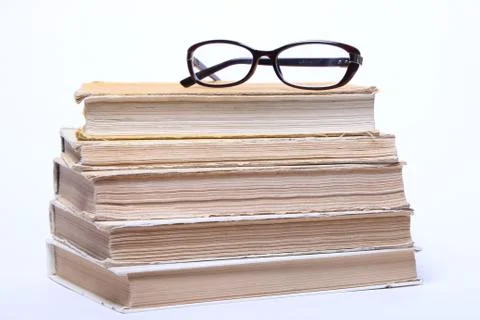 Spectacles lying on old book Stock Photos