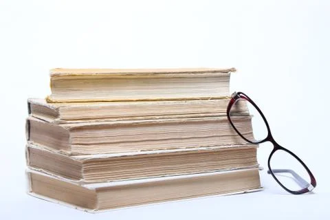 Spectacles lying on old book Stock Photos