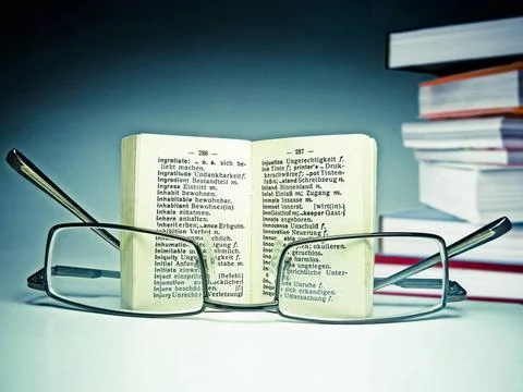 Spectacles on an opened dictionary Spectacles on an opened dictionary Copy... Stock Photos
