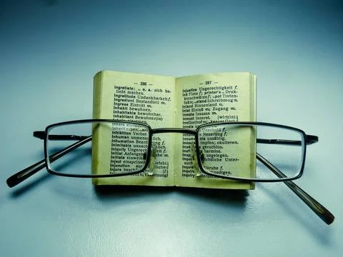 Spectacles on an opened dictionary Spectacles on an opened dictionary Copy... Stock Photos