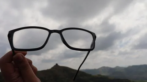 Spectacles raised high in the sky. Stock Photos