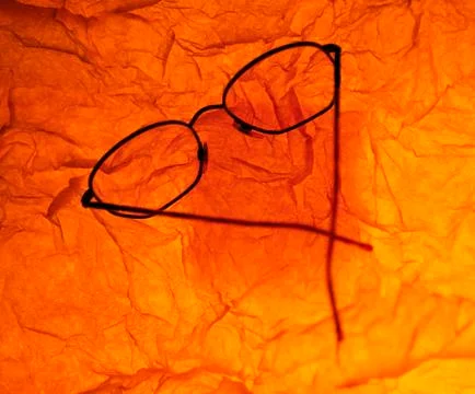 SPECTACLES ON RED TISSUE PAPER Stock Photos