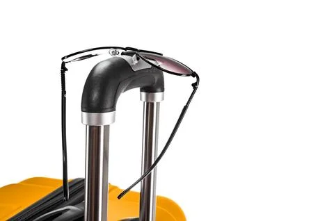 Spectacles on suitcase handle Stock Photos