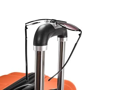 Spectacles on suitcase handle Stock Photos