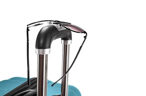 Spectacles on suitcase handle Stock Photos