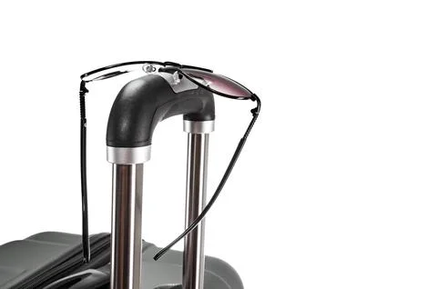 Spectacles on suitcase handle Stock Photos