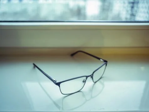 Spectacles on a window sill 写真素材