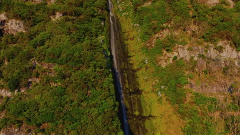 Spectacular aerial drone medium view of a tall, powerful waterfall cascading Stockbeeldmateriaal 336263544