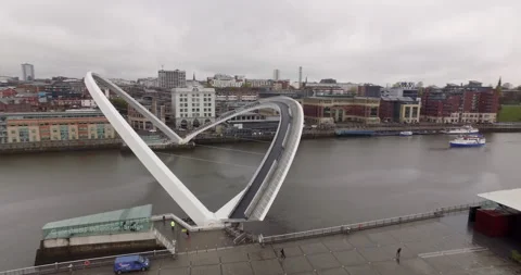 Spectacular Aerial moving around Gateshead Millenium Bridge over River Tyne Stock Footage 159129953