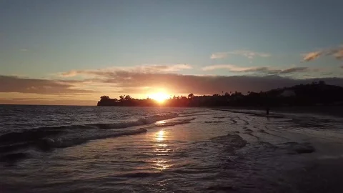 Spectacular Beach Sunset with Waves Breaking Aerial Stock Footage 83221065