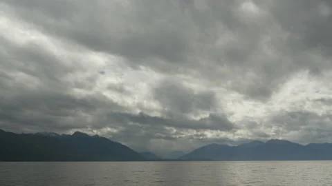 Spectacular clouds over a lake surrounded by mountains, in New Zealand Stock Footage 219245448