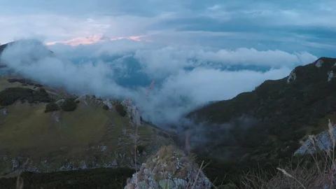 Spectacular cloudy landscape with mountains and misty alpine forest at sunset Stock Footage 86217042