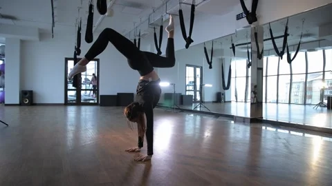 A spectacular dance performance in a studio, featuring aerial yoga elements and Stock Footage 307895020