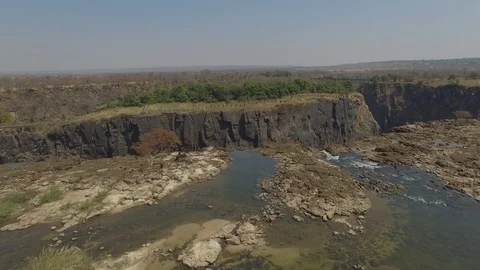 Spectacular Drone Shot of Devils Pool above a Waterfall and a rainbow in Stock Footage 97388102