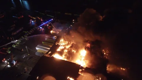 Spectacular drone view of fire at night with flames burning throughout building Video stock 92644031