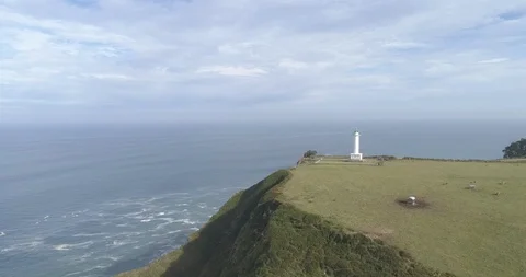 Spectacular drone view of a lighthouse on top of high cliffs in Spain Stock Footage 111841334