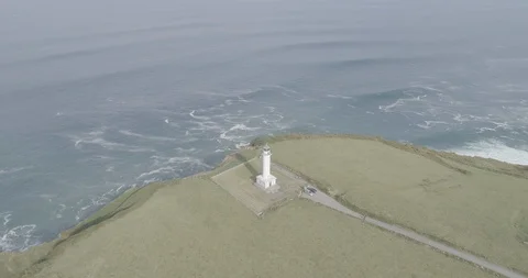 Spectacular drone view of a lighthouse on top of high cliffs in Spain Stock Footage 111841449