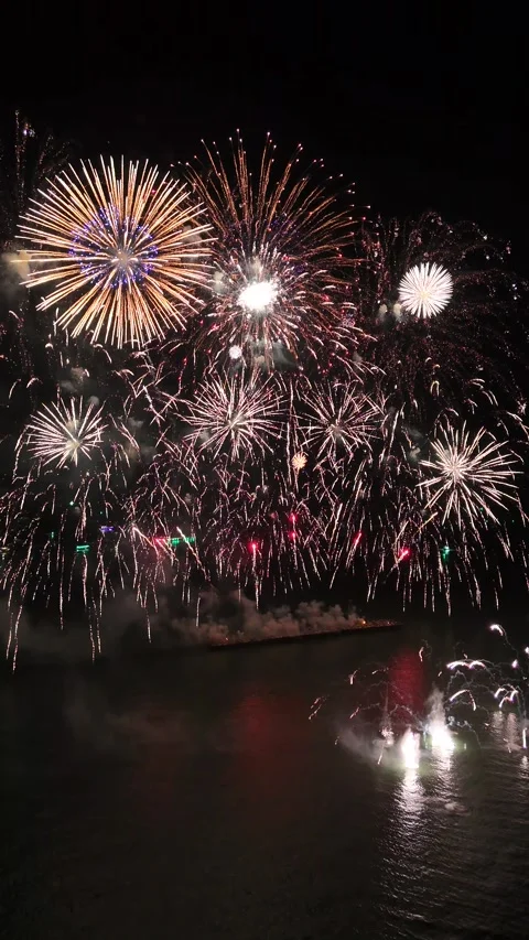 Spectacular Fireworks Celebration Exploding Over Water at Night in Pattaya, Stock Footage 335843800