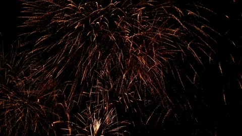 Spectacular fireworks display exploding against dark sky at night Stock Footage 100521356