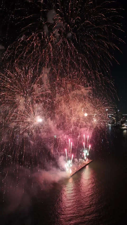 Spectacular Fireworks Display Exploding Over Water at Night in Pattaya, Thailand Stock Footage 335842626