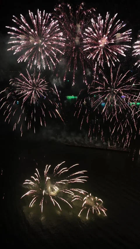 Spectacular Fireworks Display Exploding Over Water at Night in Pattaya, Thailand Stock Footage 335843747