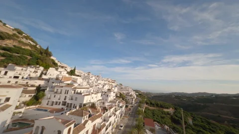 Spectacular flight of an FPV drone over the roofs of a typical Andalusian villag Stock Footage 146013579