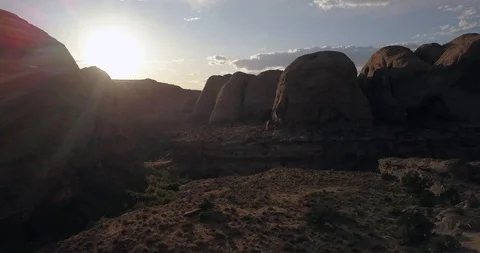 Spectacular flight through red rock canyon at sunset with god rays Video stock 117864683