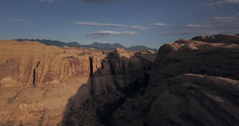 Spectacular flight through red sandstone canyon and arch -- view of ridge beyond Stock Footage 117864819