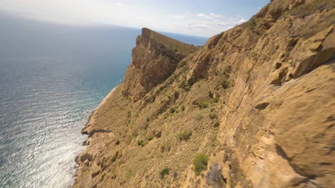 Spectacular FPV flight over a very high cliff over the sea Stock Footage 146484290
