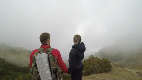 Spectacular high view of mountain landscape full of floating mist admired by  Stock Footage 86218433